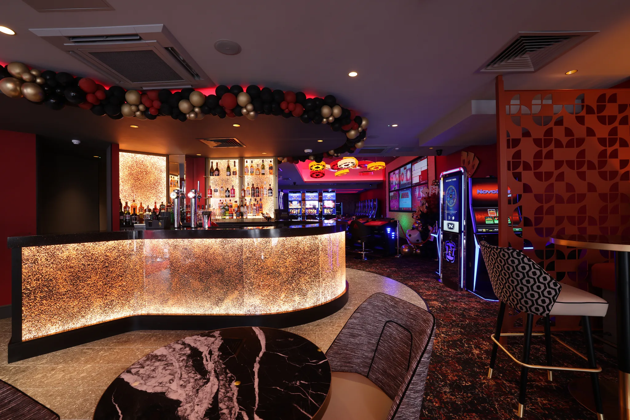 The fully licensed bar with curved illuminated counter and seating
